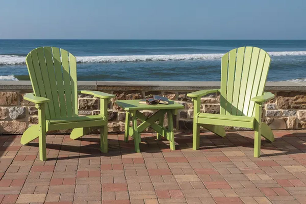 Two Green Wooden Chairs with a Small Green Table with the Ocean Behind